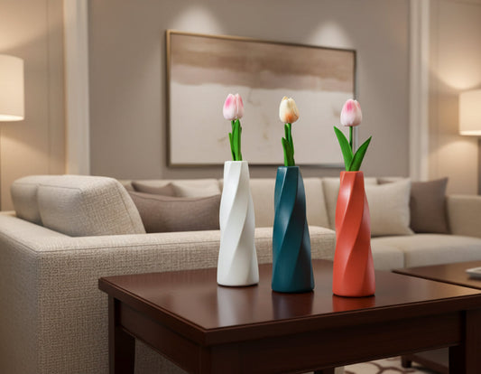 Three colorful vases with tulip flowers on a table against a green curtain background